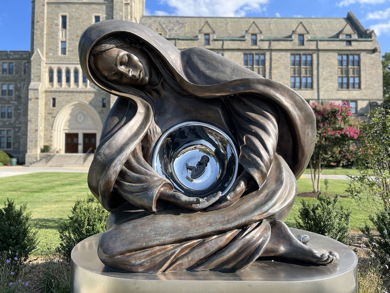 Canadian sculptor Timothy Schmalz says Advent is a representation of Jesus as a fetus, resting in a woman made of mystical material that represents God’s creation. His largest version, known as the National Life Monument, was blessed by a group of male Catholic leaders at the Catholic University of America on May 17, 2023. (Sofia Resnick/States Newsroom)