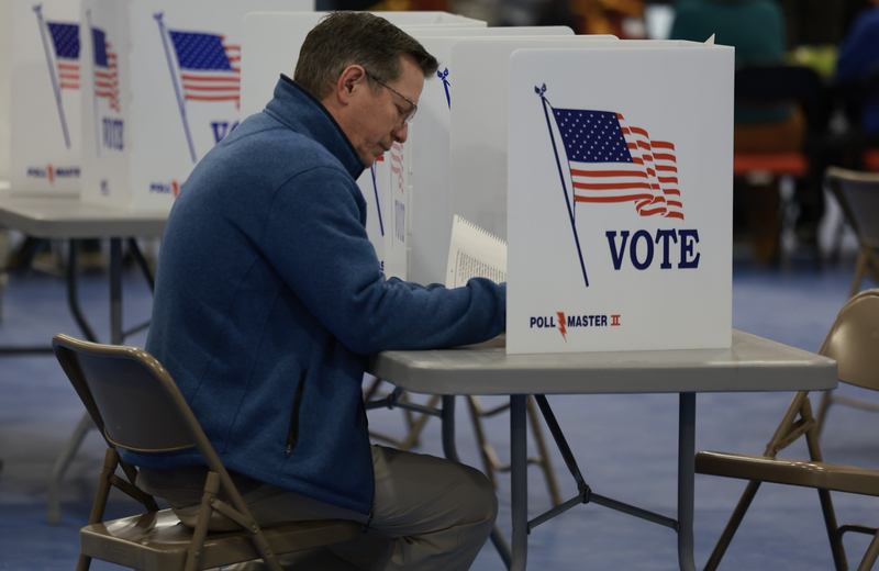 A voter fills out their ballot at a polling location at Bedford High School on January 23, 2024 in Bedford, New Hampshire. Voters headed to the polls as New Hampshire holds its primary. (Photo by Joe Raedle/Getty Images)
