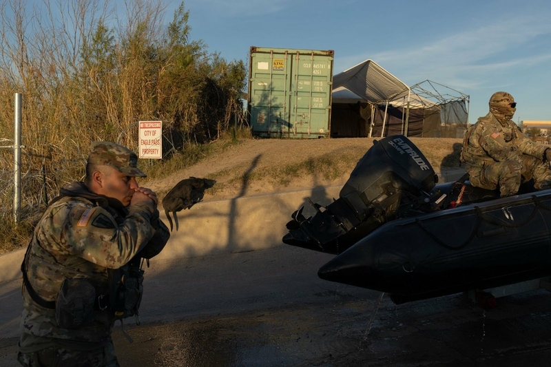 Texas National Guard members load a boat into a pickup at the boat ramp in Shelby Park in Eagle Pass on Jan. 16, 2024. (Photo by Eddie Gaspar / The Texas Tribune)