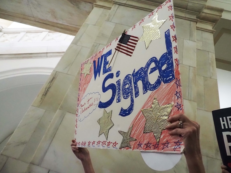 A supporter of the Arkansas Abortion Amendment holds up a sign in a Capitol hallway where petitions to put the amendment on the November ballot were delivered Friday, July 5. (Tess Vrbin/Arkansas Advocate)