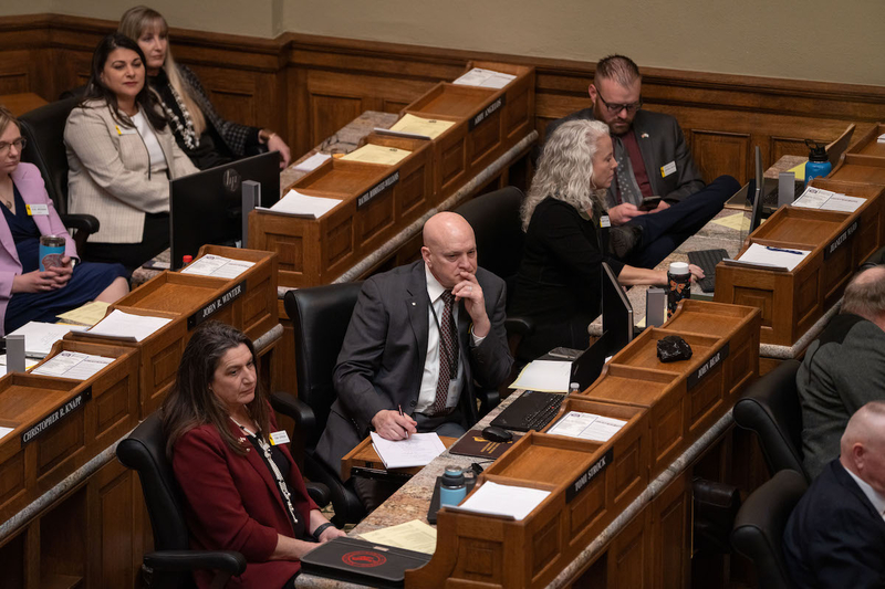 Rep. John Bear, the then-chairman of the hard-line Wyoming Freedom Caucus, listens as Gov. Mark Gordon delivers his State of the State address to the Wyoming Legislature on Feb. 12, 2024 in Cheyenne. To his left and right are Freedom Caucus members and Reps. Tomi Strock, Jeannette Ward and Jeremy Haroldson. Seated behind him in the tan jacket is another Freedom Caucus member, Rep. Rachel Rodriguez-Williams. (WyoFile/Ashton J. Hacke)