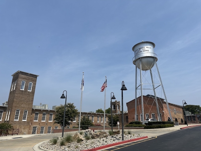 A former cotton mill built and once operated by slave labor, Rocky Mount Mills closed in 1996, reopened in 2015 and is now home to breweries, restaurants and dozens of high-end apartments. (Kevin Hardy/Stateline)