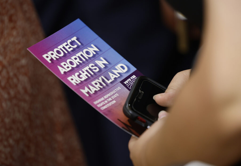 An audience member holds a brochure on Question 1 during a reproductive rights rally featuring Vice President Kamala Harris on Monday, June 24, in College Park, Maryland. The state has a parental notification law for minors seeking abortions. (Kevin Dietsch/Getty Images)