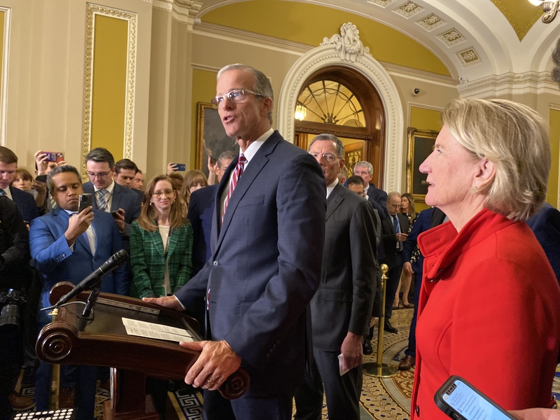 South Dakota Sen. John Thune speaks to reporters after being elected Republican leader during a closed-door, secret ballot election held inside the old Senate chamber in the U.S. Capitol building on Wednesday, Nov. 13, 2024. At right is Sen. Shelley Moore Capito, a West Virginia Republican elected as the Republican Policy Committee chair. (Photo by Jennifer Shutt/States Newsroom)