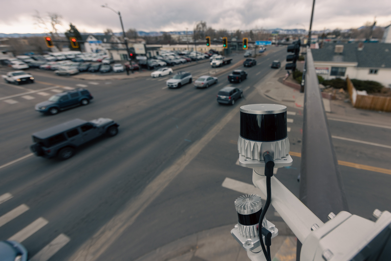 A LiDAR sensor from technology company Ouster, shown in an intersection in Colorado, uses a laser to create anonymous 3-D models of the people and vehicles at street level. (Photo courtesy of Ouster)
