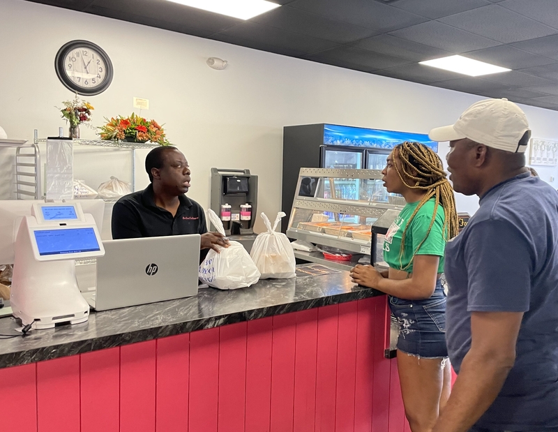 Customers picking up food at Rose Goute Creole in Springfield, OH. (Photo by Nick Evans, Ohio Capital Journal)