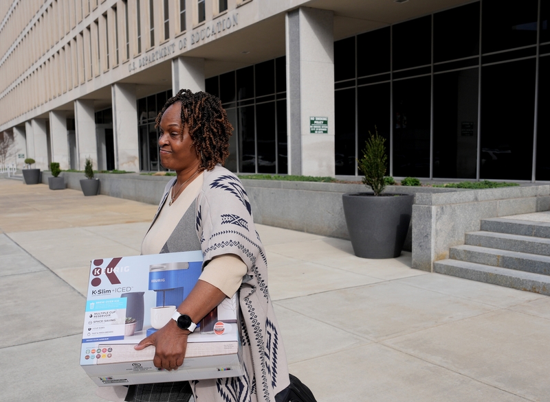 A U.S. Department of Education employee leaves the building with their belongings on March 20, 2025 in Washington, D.C. (Photo by Win McNamee/Getty Images)