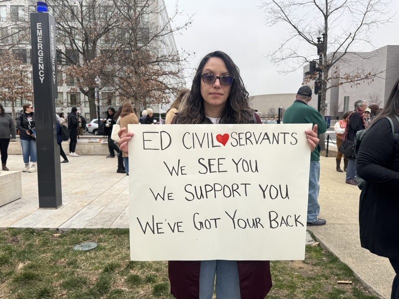 Antoinette Flores, who worked for the U.S. Department of Education during the Biden administration, protests the agency's mass layoffs during Friday's "honk-a-thon" and rally. (Photo by Shauneen Miranda/States Newsroom)