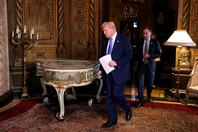 President Donald Trump, accompanied by White House staff secretary Will Scharf, delivers remarks before signing an executive order on expanding access to IVF at his Mar-a-Lago resort on Feb. 18, 2025 in Palm Beach, Florida. (Photo by Joe Raedle/Getty Images)
