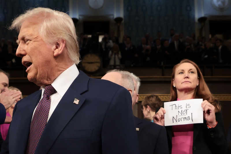 President Donald Trump arrives for his speech to a joint session of Congress as Rep. Melanie Stansbury, D-N.M., holds a sign reading "This is not normal" at the U.S. Capitol on March 4, 2025, in Washington, D.C.. (Photo by Win McNamee/Getty Images)