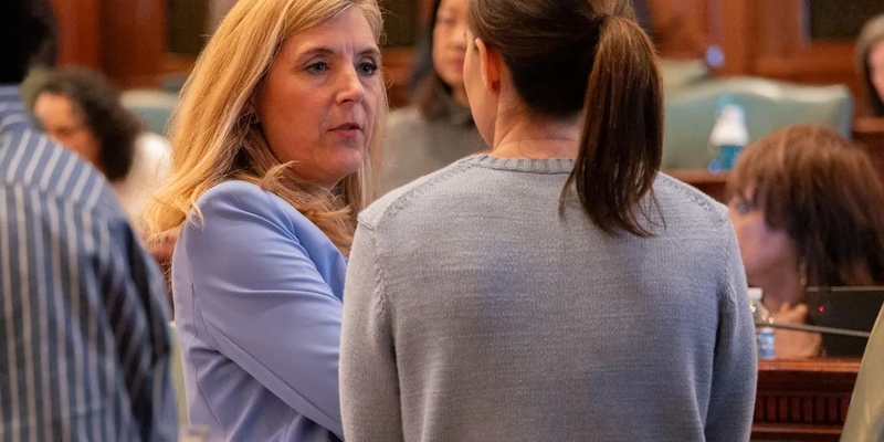 Rep. Terra Costa Howard, D- Glen Ellyn, speaks to a House colleague shortly after making a speech on April 11, 2025, in favor of her bill creating new homeschool oversight in Illinois. (Capitol News Illinois photo by Andrew Adams)