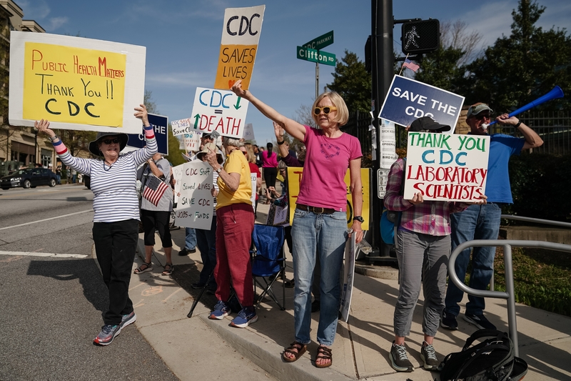 People demonstrate outside the main campus of the Centers For Disease Control and Prevention on April 1, 2025 in Atlanta, Georgia. Health and Human Services Secretary Robert F. Kennedy Jr. laid off thousands of employees across multiple agencies today, as part of an overhaul announced in March. (Photo by Elijah Nouvelage/Getty Images)