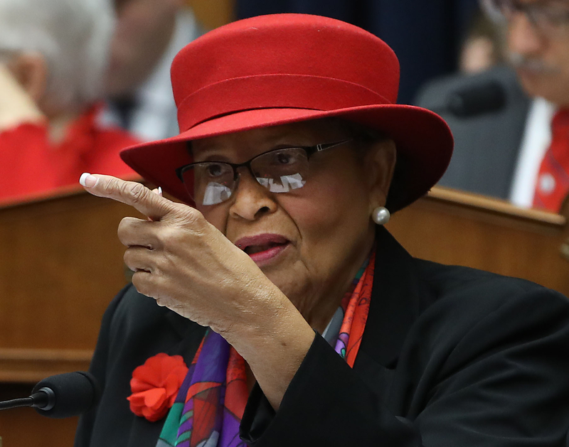 Democratic U.S. Rep. Alma Adams of North Carolina makes a point on the House floor wearing a red hat