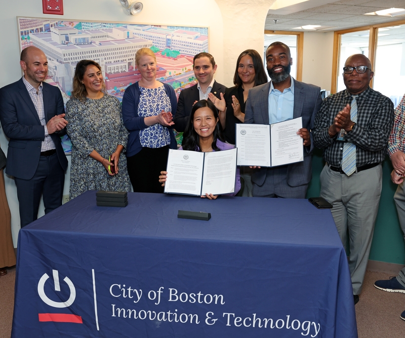 Mayor Michelle Wu signs the Technology Modernization Executive Order on Aug. 18 to accelerate improvements to the City of Boston's tech infrastructure and digital processes, making it easier to harness innovation and keep projects moving forward. (Photo courtesy of the Boston Department of Innovation &amp; Technology)
