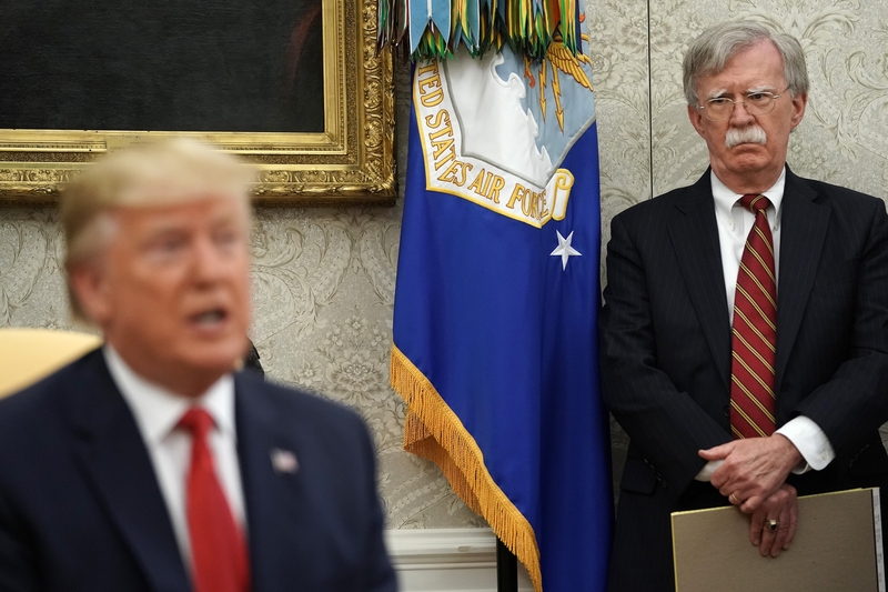 WASHINGTON, DC - JULY 18: White House National Security Advisor John Bolton (R) listens to U.S. President Donald Trump as he and Dutch Prime Minister Mark Rutte talk to reporters in the Oval Office at the White House July 18, 2019 in Washington, DC. According to the Dutch government, the two leaders will discuss defense and security cooperation, especially focused on whether the Netherlands will participate in a global effort to secure international waterways against threats from Iran. (Photo by Chip Somode