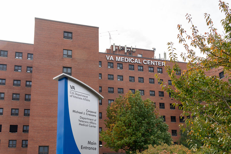 A Veterans Affairs medical center stands against a gray sky.