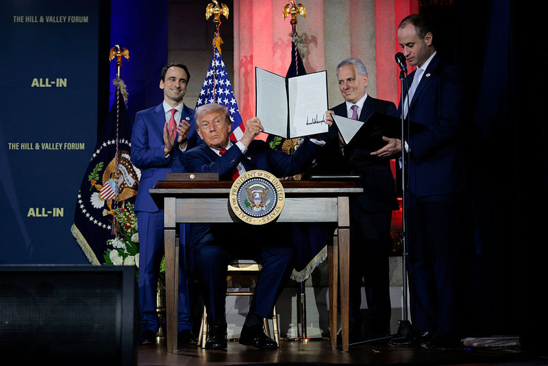 U.S. President Donald Trump displays a signed executive order during the "Winning the AI Race" summit hosted by All‑In Podcast and Hill &amp; Valley Forum at the Andrew W. Mellon Auditorium on July 23, 2025 in Washington, DC. Trump signed executive orders related to his Artificial Intelligence Action Plan during the event. (Photo by Chip Somodevilla/Getty Images)