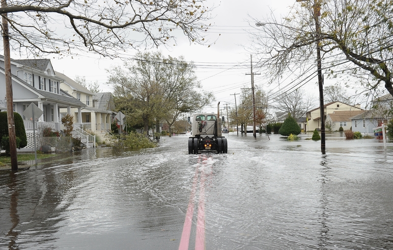 A truck cab drives through a neighborhood flooded by Hurricane Sandy on Oct. 30, 2012 in Point Pleasant Beach, New Jersey. (Photo by Michael Loccisano/Getty Images)