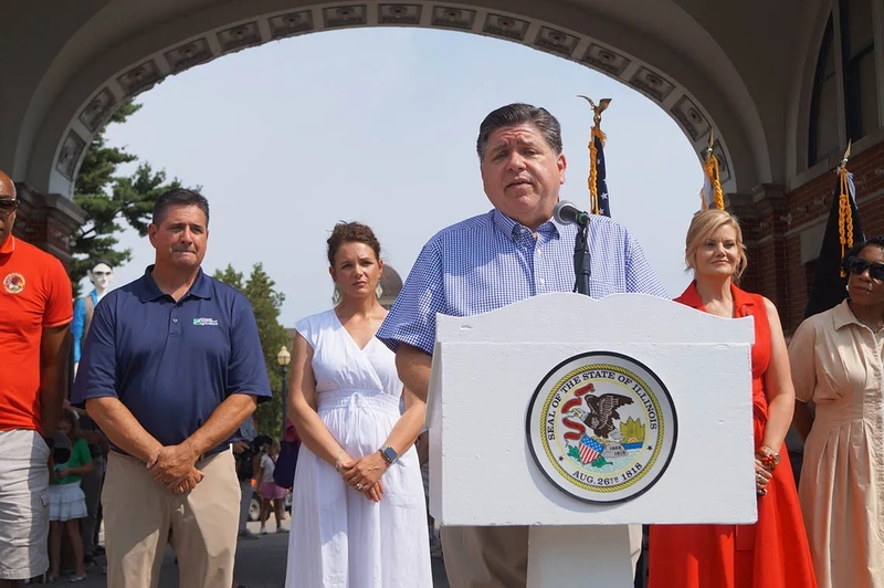 Gov. JB Pritzker speaks to reporters outside the Illinois State Fairgrounds after cutting a ribbon to officially open the fair on Thursday, Aug. 7, 2025. (Capitol News Illinois photo by Peter Hancock)