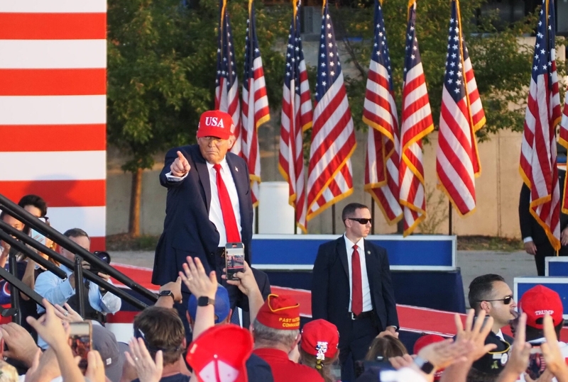 President Donald Trump waved and pointed to the crowd as he exited the stage following his remarks at the Iowa State Fairgrounds July 3, 2025 at an event kicking off a yearlong celebration leading up to America’s 250th anniversary. (Photo by Robin Opsahl/Iowa Capital Dispatch)