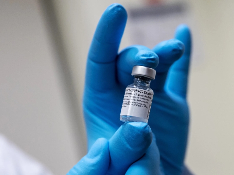 Army Spc. Angel Laureano holds a vial of the COVID-19 vaccine, Walter Reed National Military Medical Center, Bethesda, Md., Dec. 14, 2020. (DoD photo by Lisa Ferdinando) Credit: Office of the Secretary of Defen