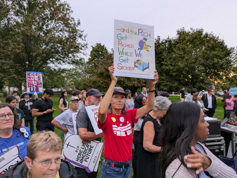 onna Powell, 66, a resident of Austin, Texas, who is temporarily living in the nation's capital holds a sign at the "Healthcare Over Billionaires" rally hosted by Fair Share America and nearly three dozen other advocacy organizations outside the U.S. Capitol on Tuesday, Sept. 30, 2025, hours before federal government funding ran out at midnight. (Photo by Ashley Murray/States Newsroom)