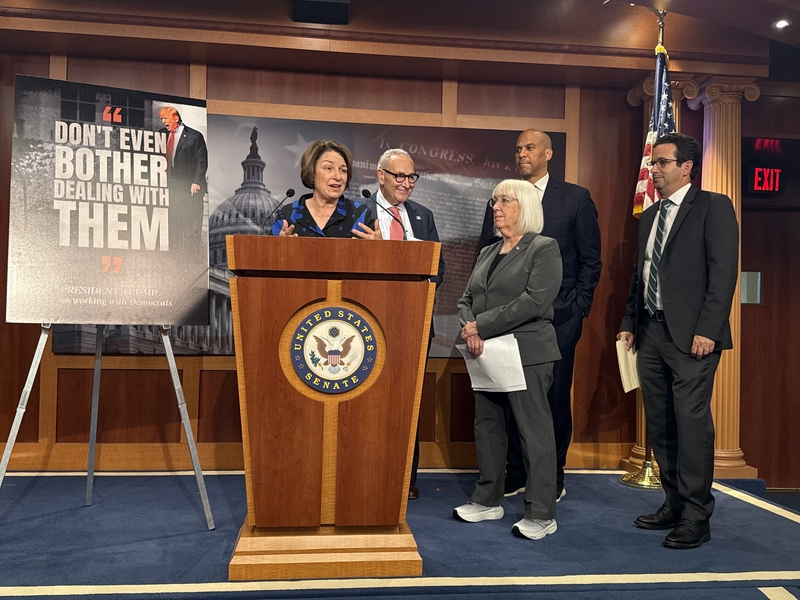 Minnesota Democratic U.S. Sen. Amy Klobuchar speaks with reporters inside the Capitol building in Washington, D.C., on Friday, Sept. 19, 2025. Also pictured, from left to right, are Senate Minority Leader Chuck Schumer, D-N.Y.; Washington state Democratic Sen. Patty Murray, New Jersey Democratic Sen. Cory Booker and Hawaii Democratic Sen. Brian Schatz. (Photo by Jennifer Shutt/States Newsroom)