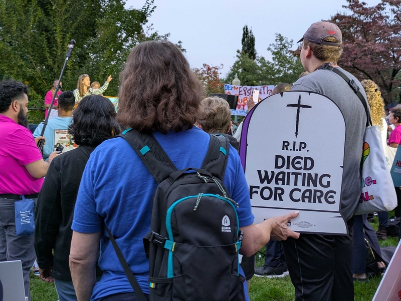 An advocate holds an SEIU sign protesting rising health care costs at a demonstration near the U.S. Capitol on Tuesday, Sept. 30, 2025.  (Photo by Ashley Murray/States Newsroom)