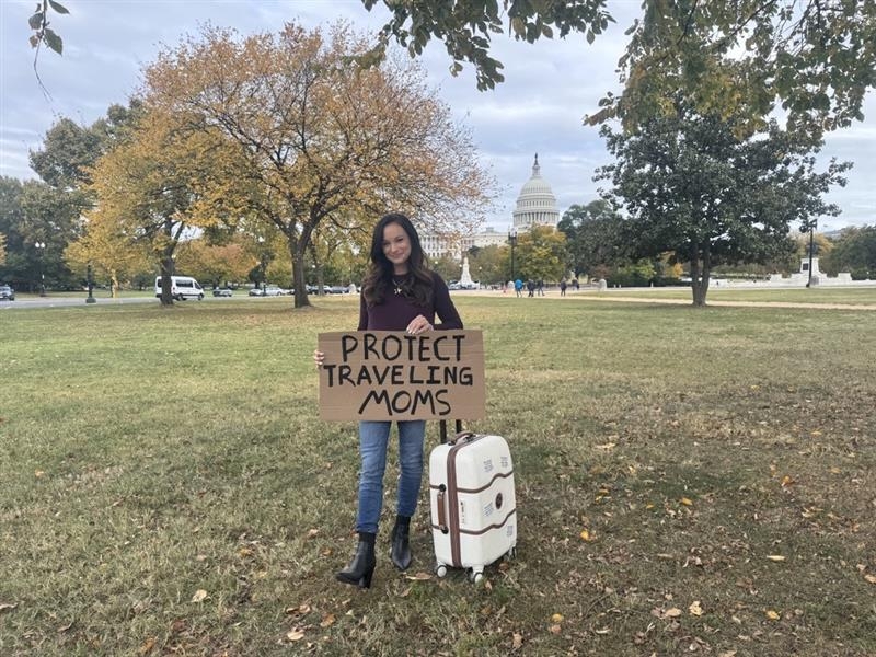 Engineer and TV host Emily Calandrelli stands with a sign in D.C.