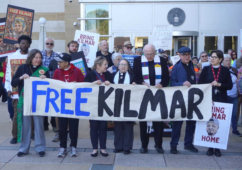 Rallygoers hold a sign that reads “Free Kilmar” during a rally Friday, Oct. 10, 2025, outside the U.S. District Court in Greenbelt, Maryland. (Photo by William J. Ford/Maryland Matters)