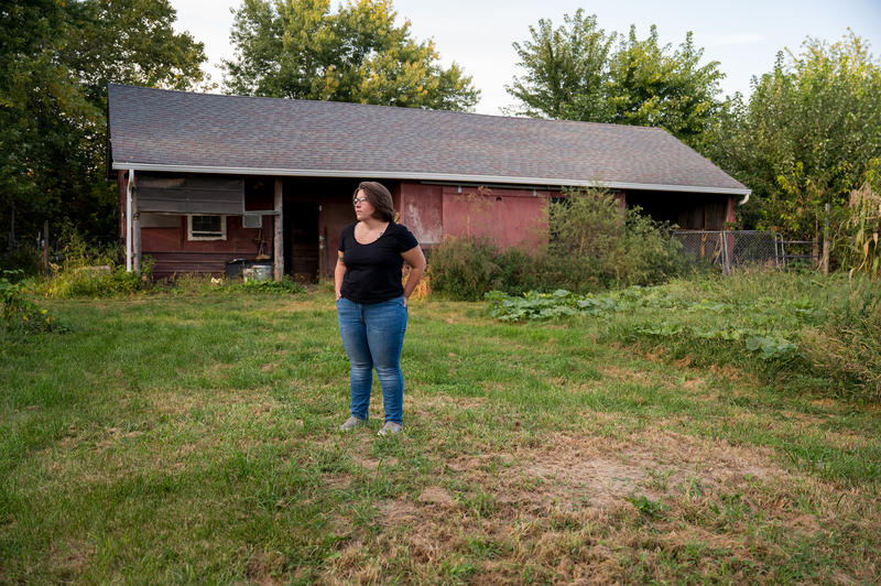 Sarah Elgatian stands in front of her home in rural Iowa.