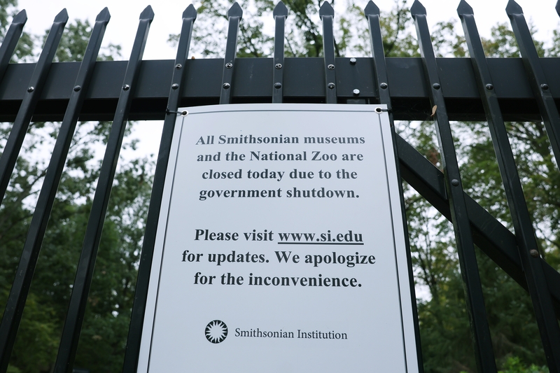 A sign with a notice of closure is seen pinned on the fence to the National Zoo on Oct. 12, 2025, in Washington, D.C. . The closure affects all the Smithsonian's 21 museums, its research centers and the National Zoo. (Photo by Anna Moneymaker/Getty Images)