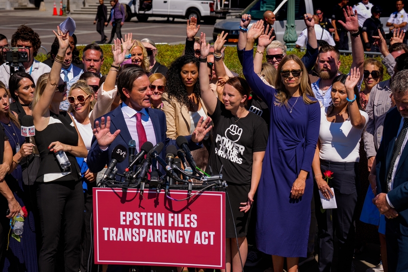 Women who say they were abused by disgraced financier and sex trafficker Jeffrey Epstein raise their hands as attorney Bradley Edwards speaks at a news conference outside the U.S. Capitol on Sept. 3, 2025 in Washington, DC. (Photo by Andrew Harnik/Getty Images)