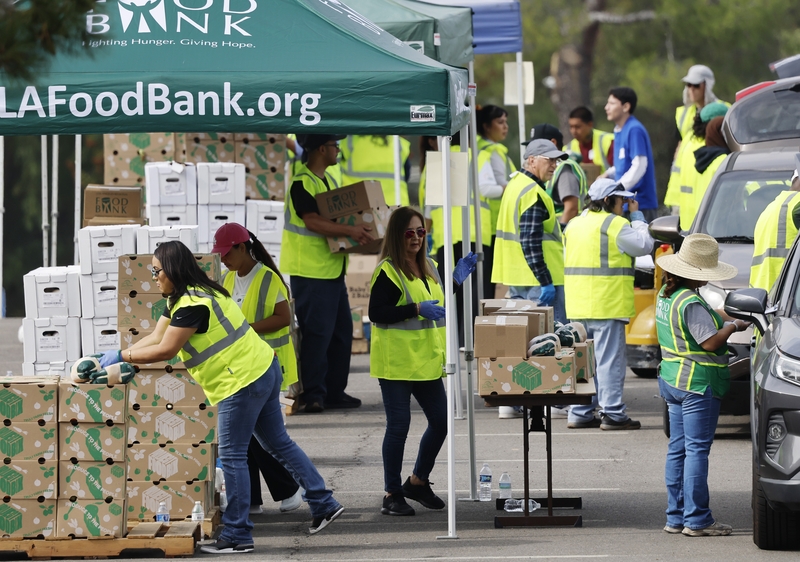 Workers and volunteers help distribute food boxes to those in need at a large-scale drive-through food distribution, in response to the federal government shutdown and SNAP/CalFresh food benefits delays, on Nov. 5, 2025 in City of Industry, California. (Photo by Mario Tama/Getty Images)