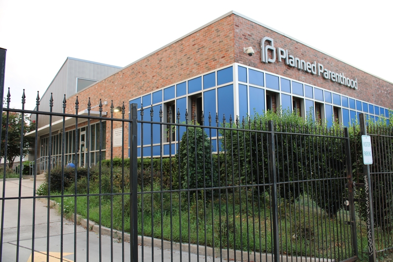 The Planned Parenthood clinic in New Orleans stands behind a tall iron fence.