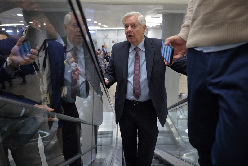 Sen. Lindsey Graham, R-S.C., talks with reporters as he arrives at the U.S. Capitol on Feb. 20, 2025 in Washington, D.C.  Graham is one of eight senators who could sue the government over an FBI subpoena of his cell phone call logs, under a law passed to reopen the government. (Photo by Chip Somodevilla/Getty Images)