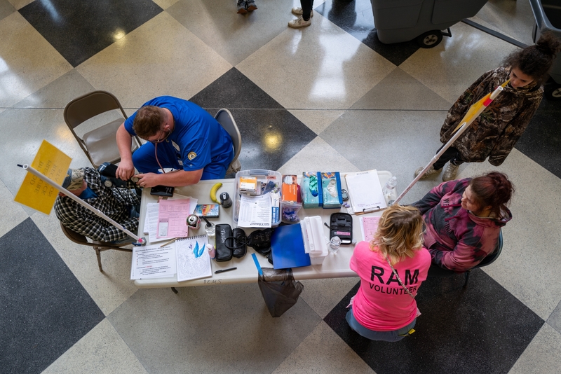 Patients have their blood pressure checked and other vitals taken at an intake triage at a Remote Area Medical mobile dental and medical clinic on Oct. 07, 2023 in Grundy, Virginia. (Photo by Spencer Platt/Getty Images)