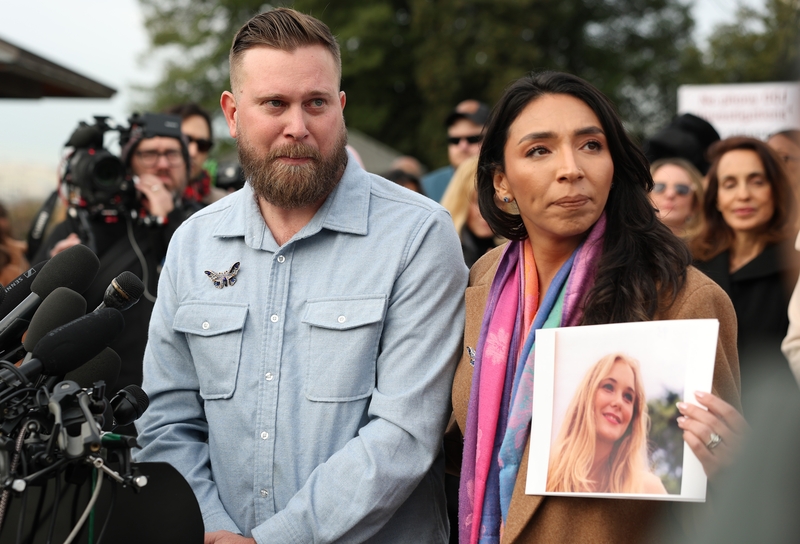 Sky Roberts, left, brother of Virginia Giuffre, who was abused by Jeffrey Epstein, and his wife Amanda Roberts hold up a photo of Giuffre during a news conference on the Epstein Files Transparency Act outside the U.S. Capitol on Nov. 18, 2025 in Washington, D.C. (Photo by Anna Moneymaker/Getty Images)