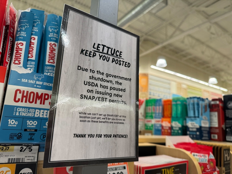 A sign explaining delays in the Supplemental Nutrition Assistance Program during the government shutdown is displayed at a Sprouts grocery store in Bountiful, Utah, on Wednesday, Nov. 12, 2025. (McKenzie Romero/Utah News Dispatch)