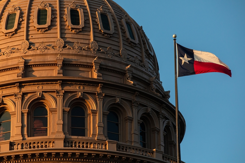 The Texas Capitol building and the Texas state flag