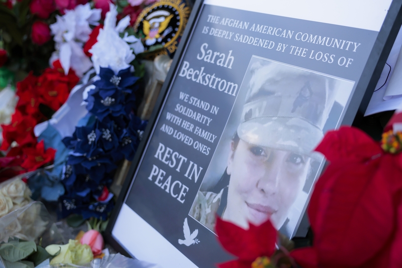 A makeshift memorial of flowers and American flags honoring the late West Virginia National Guard member Sarah Beckstrom stands outside the Farragut West Metro station on Dec. 1, 2025 in Washington, D.C.  (Photo by Heather Diehl/Getty Images)