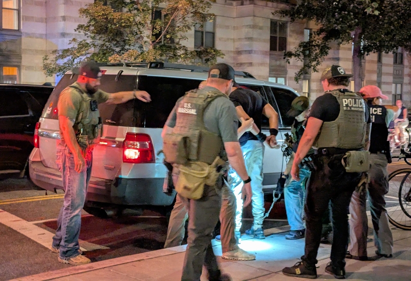 U.S. Marshals and Homeland Security Investigations agents take a man into custody at the intersection of 14th and N streets NW in Washington, D.C., on Sept. 3, 2025. (Photo by Ashley Murray/States Newsroom)