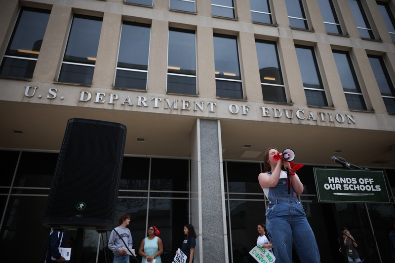 Student protestors shout during a “Hands Off Our Schools” rally in front of the U.S. Department of Education’s Washington, D.C., headquarters in April. Students from several colleges and universities gathered to protest President Donald Trump dismantling of the department. (Photo by Kayla Bartkowski/Getty Images)