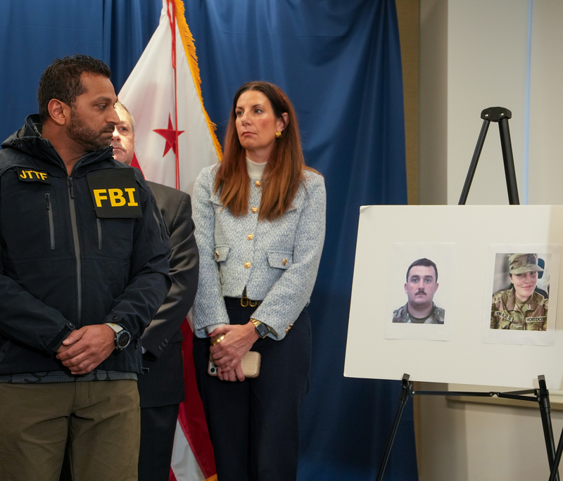 FBI Director Kash Patel (L) looks at photos of the two West Virginia National Guard soldiers shot in Washington, D.C., along with the suspect in the shooting on November 27, 2025 in Washington, DC. Two members of the West Virginia National Guard were shot blocks from the White House in what authorities are calling a targeted shooting.