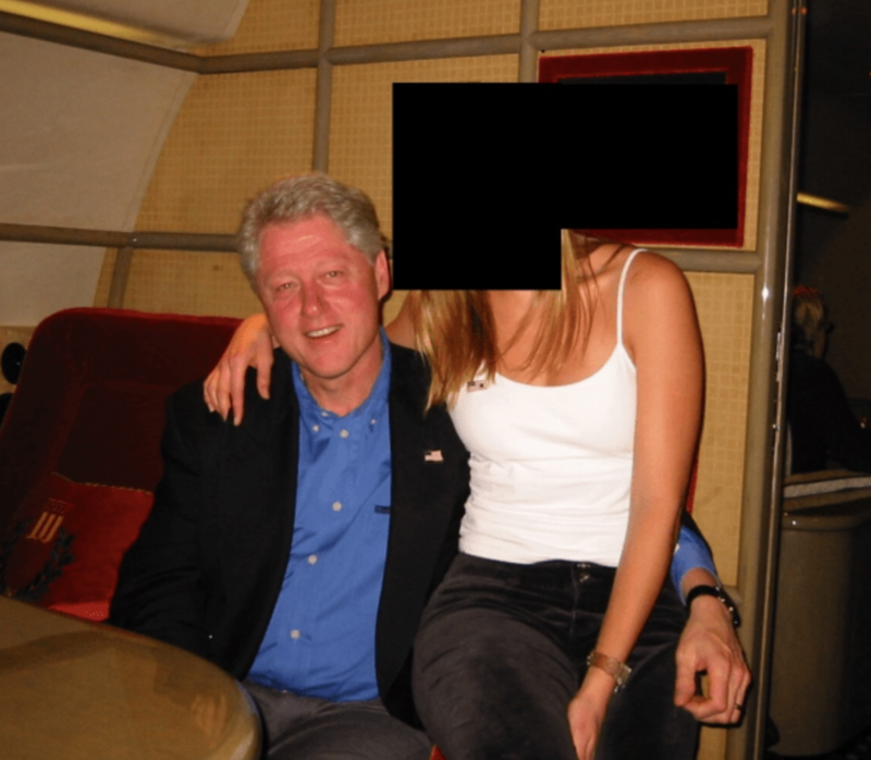 Former President Bill Clinton is seen posing with a woman, whose face is redacted, on his lap in one of the images released by the Department of Justice on Dec. 19, 2025, as part of a trove of Epstein case files. (Photo by Department of Justice)