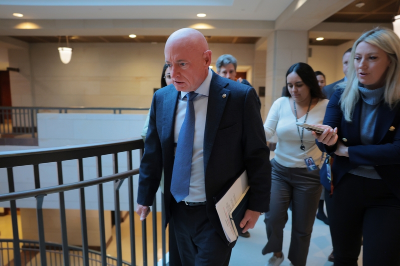 U.S. Sen. Mark Kelly, D-Ariz., walks to a closed-door briefing with the Senate Armed Services Committee at the U.S. Capitol on Dec. 2, 2025 in Washington, D.C. Senators attending the long scheduled briefing on naval aviation mishaps were asked by reporters about the recent U.S. strike on a ship in the Caribbean. (Photo by Anna Moneymaker/Getty Images)