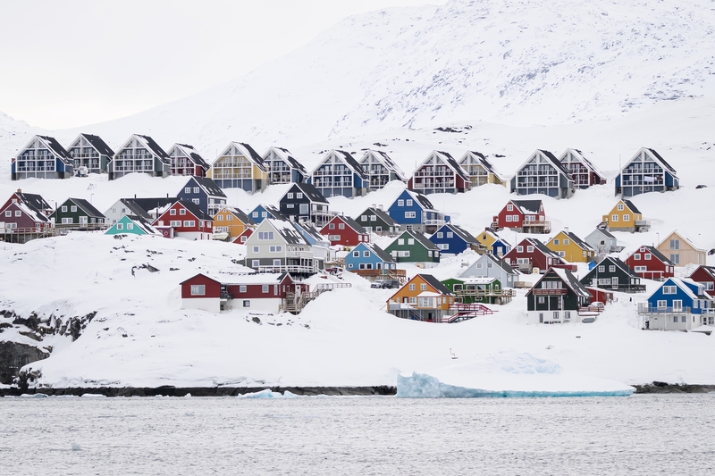 Multi-coloured traditional Greenlandic homes are seen from the water during a pleasure trip on March 29, 2025 in Nuuk, Greenland. The Arctic territory is experiencing an unexpected surge in tourism, fuelled by both the opening of a new international airport in the capital, Nuuk, and US President Donald Trump’s recent controversial announcement that he plans to annex the territory. Recent figures show a 14% rise in the number of visitors in January, with tourism operators confirming an increase in bookings s