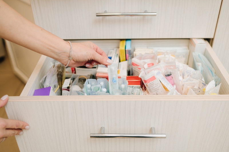 A physician opens a drawer of birth control options.