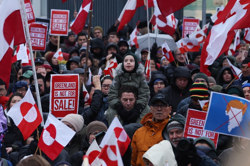 People hold Greenlandic flags as they gather to march in protest against U.S. President Donald Trump and his announced intent to acquire Greenland on Jan. 17, 2026 in Nuuk, Greenland. (Photo by Sean Gallup/Getty Images)