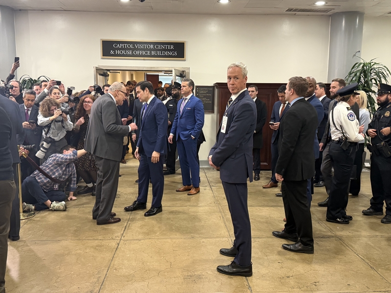 Senate Minority Leader Chuck Schumer, D-N.Y., speaks with Secretary of State Marco Rubio as Defense Secretary Pete Hegseth stands to the side in the U.S. Senate basement following a classified briefing on President Donald Trump's foreign policy plans on Wednesday, Jan. 7, 2026. (Photo by Jennifer Shutt/States Newsroom)
